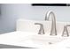 Close-up of a bathroom sink with a brushed nickel faucet and white countertop at 5955 E 10Th Ave # 507, Denver, CO 80220