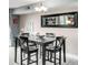 Bright dining area with a modern chandelier and ample seating at 5955 E 10Th Ave # 507, Denver, CO 80220