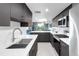 An open concept kitchen with modern appliances seamlessly flows into a sunlit living space at 5955 E 10Th Ave # 507, Denver, CO 80220