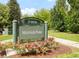 Mayfair Park sign surrounded by rose bushes, trees, and a grassy area at 5955 E 10Th Ave # 507, Denver, CO 80220