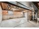 Unfinished basement with exposed wood beams, concrete floor, and a window for natural light at 4272 E 126Th Pl, Thornton, CO 80241