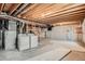 Spacious unfinished basement with exposed wood beams and visible ductwork, containing washer and dryer at 4272 E 126Th Pl, Thornton, CO 80241