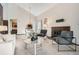 Open concept living space featuring a fireplace, comfortable seating, and a seamless flow to dining area at 4272 E 126Th Pl, Thornton, CO 80241