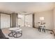Inviting living room featuring neutral carpet, a modern desk, two marble top coffee tables, and a door to the outside at 4272 E 126Th Pl, Thornton, CO 80241