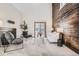 Spacious living room with a modern accent wall, comfortable seating, and sliding glass doors to outside at 4272 E 126Th Pl, Thornton, CO 80241