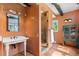 Bathroom featuring an pedestal sink and a walk-in shower with a glass door at 50 Albion St, Denver, CO 80220