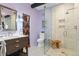 Modern bathroom with a glass shower, a floating vanity and an artistic door at 50 Albion St, Denver, CO 80220