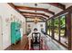 Bright dining room with exposed beams, large windows overlooking the backyard, and a vintage hutch at 50 Albion St, Denver, CO 80220