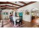 Spacious dining room with a long table, wooden beams, and terracotta floors at 50 Albion St, Denver, CO 80220