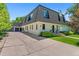 Traditional two-story home featuring a well-manicured lawn, mature trees, and an attached garage at 50 Albion St, Denver, CO 80220