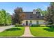 Charming home featuring a landscaped front yard, stone walkway, and mature trees in a quiet neighborhood at 50 Albion St, Denver, CO 80220