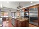 Gourmet kitchen with stainless steel appliances, custom cabinets, granite countertops, and island with sink at 50 Albion St, Denver, CO 80220