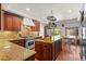 Gourmet kitchen features granite countertops, custom cabinetry, stainless steel appliances, and a center island at 50 Albion St, Denver, CO 80220