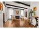 Cozy living room with a fireplace, hardwood floors, beamed ceiling, and comfortable seating at 50 Albion St, Denver, CO 80220