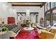 Spacious living room with exposed wood beams, hardwood floors, and large windows offering plenty of natural light at 50 Albion St, Denver, CO 80220