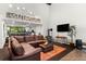 Cozy living room with a comfortable sectional, stove, and well-lit establishment sign at 50 Albion St, Denver, CO 80220