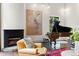 Elegant living room features a fireplace, piano, and stylish decor, creating a warm and inviting atmosphere at 50 Albion St, Denver, CO 80220