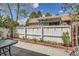 Private backyard with a patio, landscaped garden beds, a white fence, and string lights at 2012 W 101St Ave, Thornton, CO 80260
