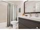 Bathroom with a tub, shower, toilet, and a vanity with drawers, plus a decorative shower curtain at 2012 W 101St Ave, Thornton, CO 80260