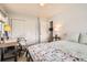 Bright bedroom featuring a full bed, desk, and ample closet space at 2012 W 101St Ave, Thornton, CO 80260