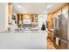 Galley kitchen with stainless steel appliances, custom wood cabinets, and tile backsplash providing a functional layout at 2012 W 101St Ave, Thornton, CO 80260