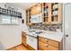 Corner view of kitchen with white countertops, glass front cabinets, and updated appliances for a modern cooking space at 2012 W 101St Ave, Thornton, CO 80260