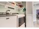 Spacious laundry room with modern washer and dryer units, shelving, and ample storage space at 2012 W 101St Ave, Thornton, CO 80260