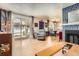 View of the living room, dining room, fireplace, and sliding glass doors that provide ample natural light at 2012 W 101St Ave, Thornton, CO 80260