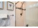 Close-up of a beautifully tiled shower with glass door and bronze fixtures at 2012 W 101St Ave, Thornton, CO 80260