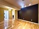 Finished basement with wood floors, modern lighting, and laundry room access at 8461 Pawnee Ln, Niwot, CO 80503