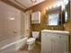 Bathroom with white tile, modern vanity, toilet, and tub/shower combo at 8461 Pawnee Ln, Niwot, CO 80503
