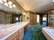 Bathroom featuring a soaking tub, double vanity, and a walk-in shower at 8461 Pawnee Ln, Niwot, CO 80503