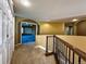 Hallway with carpeted floor, white closet doors, and decorative railing at 8461 Pawnee Ln, Niwot, CO 80503