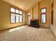 Living room with a cozy fireplace, large windows, and plush carpeting at 8461 Pawnee Ln, Niwot, CO 80503