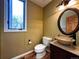 Stylish powder room with vessel sink, decorative mirror, and natural light at 8461 Pawnee Ln, Niwot, CO 80503