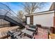 Backyard featuring an outdoor seating area, stairs, and a mix of wood and concrete surfaces at 4129 Zenobia St, Denver, CO 80212