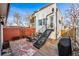 Backyard featuring a small patio area with outdoor seating and a unique staircase leading up to a door at 4129 Zenobia St, Denver, CO 80212