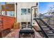 Outdoor patio setup in the backyard, featuring modern furniture and access stairs at 4129 Zenobia St, Denver, CO 80212