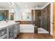 Modern bathroom with a double sink vanity, glass shower, and a built-in tub at 4129 Zenobia St, Denver, CO 80212