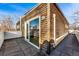 Exterior view of the wood paneled home, showing the deck and the sky at 4129 Zenobia St, Denver, CO 80212