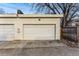 Attached two car garage with painted doors and a paved driveway at 4129 Zenobia St, Denver, CO 80212