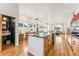 Bright kitchen with center island and modern finishes seamlessly connects to other living spaces, perfect for gatherings at 4129 Zenobia St, Denver, CO 80212