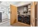 Laundry room featuring a modern front-load washer and dryer set plus shelving for storage at 4129 Zenobia St, Denver, CO 80212