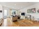 Well-lit living room with modern entertainment setup, comfortable seating, and stylish decor at 4129 Zenobia St, Denver, CO 80212