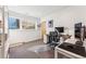 Bright home office with a large window, modern desk, and neutral carpet perfect for working remotely at 4129 Zenobia St, Denver, CO 80212