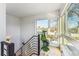 Modern staircase with sleek railings and abundant natural light from nearby windows, offering a bright and airy feel at 4129 Zenobia St, Denver, CO 80212