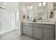 Modern bathroom with double vanity, a glass-enclosed shower, and sleek fixtures at 9865 Biscay St, Commerce City, CO 80022