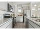 Modern kitchen featuring granite countertops, stainless steel appliances, and subway tile backsplash at 9865 Biscay St, Commerce City, CO 80022