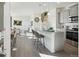 Bright open-concept kitchen featuring modern gray cabinets, granite countertops, and stainless steel appliances at 9865 Biscay St, Commerce City, CO 80022