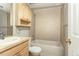 Bright bathroom featuring a bathtub, a tiled shower, and a wooden cabinet at 6380 S Boston St # 397, Greenwood Village, CO 80111